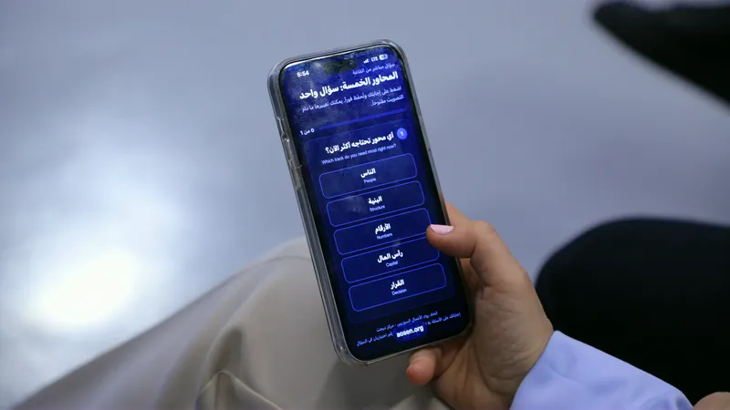 A guest answers the live poll questions on the five tracks from their phone at the EntreStations launch